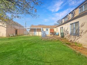 a house with a lawn in front of it at Brownfield BlueBird House - 6 bedrooms in Brownfield