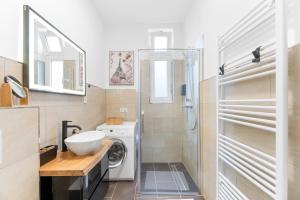 a bathroom with a washing machine and a sink at Elite Weser Apartments in Bremen +71 photos