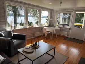 a living room with a couch and a table at Schwedenhaus am See in Storfors