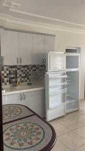 a kitchen with an open refrigerator in a kitchen at Marin Apart Arsuz in Arsuz +2 photos