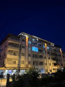 a large building at night with lights on it at Marin Apart Arsuz in Arsuz