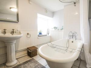 a white bathroom with a tub and a sink at Rowan Tree House in Brechin +44 photos