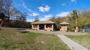 a small building in a park with a playground at Red Brick 