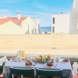 a table with a plate of food on it with the ocean at Son Serra Holidays House ETV6786 in Son Serra de Marina