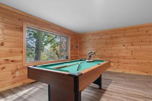 a pool table in a room with wooden walls at Cozy Cabin Sleeps 10 Hot Tub Pool Table Arcade in Shady Grove