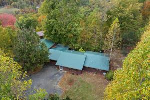 an overhead view of a house with a blue roof at Cozy Cabin Sleeps 10 Hot Tub Pool Table Arcade in Shady Grove
