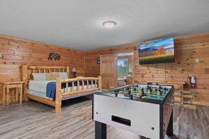 a bedroom with a bed and a chess board at Cozy Cabin Sleeps 10 Hot Tub Pool Table Arcade in Shady Grove +39 photos