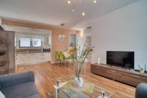 a living room with a couch and a tv at City Center Appartment with parking in Trnava