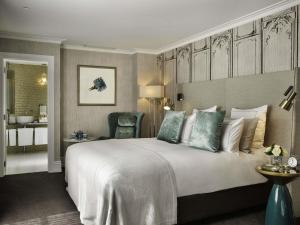 a hotel room with a large bed and a bathroom at Fable Auckland, MGallery in Auckland