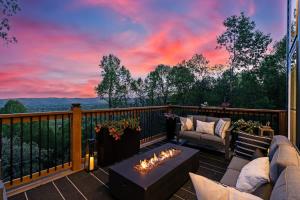 a patio with a fire pit and a sunset at LUXE, Breathtaking Mountain Views, Hot Tub, Fire Pit, Fire Pit Table, Pool Table, 2 Living rooms, Universal EV Station in Hendersonville +82 photos