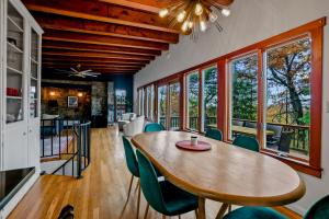 a dining room with a wooden table and chairs at Stone Cabin on Valley View - Firepit & Hot Tub in Harpers Ferry +47 photos