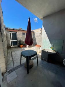 a table with an umbrella on a patio at Casa Relax in Simaxis