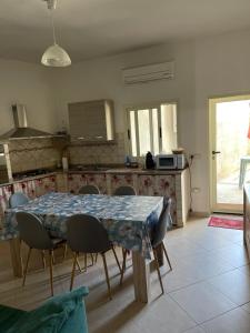 a kitchen with a table and chairs and a table and a kitchen at Casa Relax in Simaxis