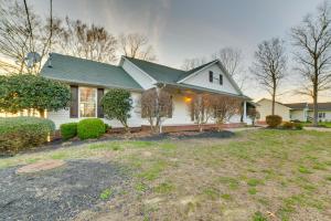 ein weißes Haus mit grünem Dach in der Unterkunft Peaceful Big Sandy Home with Deck on Kentucky Lake! in Big Sandy