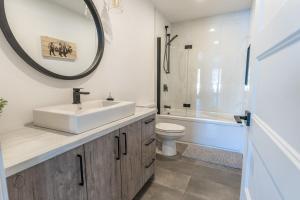 a bathroom with a sink and a toilet and a mirror at Le Panorama spa lake access in Saint Come +39 photos