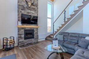 a living room with a couch and a fireplace at Le Panorama spa lake access in Saint Come