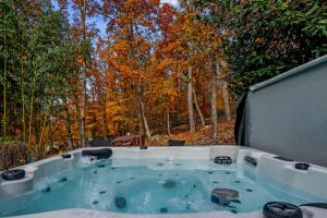 a jacuzzi tub in the middle of the woods at Stone Cabin on Valley View - Firepit & Hot Tub in Harpers Ferry