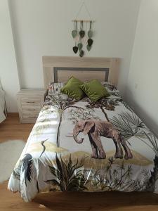 a bedroom with a bed with an elephant on it at Dúplex JUNI in Bádames