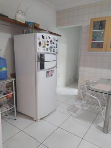 a white refrigerator in a kitchen with a table at Sebastião Arruda Júnior Recife Boa Vista in Recife