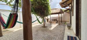 a patio with hammocks hanging from a building at Pousada Coró in São Miguel do Gostoso +8 photos