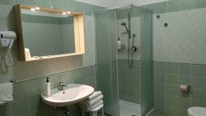 a bathroom with a shower and a sink and a shower at Hotel Ariston Imperial in Porto Garibaldi +28 photos