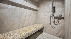 a shower stall with a bench in a bathroom at Ρομαντική απόδραση με Χαμάμ in Athens +19 photos