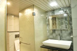 a bathroom with a sink and a mirror at Nest & Fest in Indore +32 photos