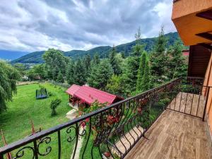 a balcony of a house with a view of the mountains at Casa Florina in Predeluţ