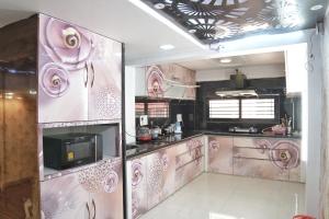 a kitchen with pink walls and appliances in a room at Nest & Fest in Indore
