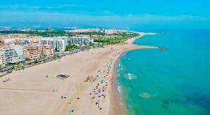 an overhead view of a beach with people and the ocean at Bonita Planta baja con patio en 1ª línea de playa in Puerto de Sagunto +25 photos