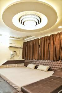 a room with a large ceiling with a large bed at Nest & Fest in Indore