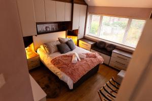 a bedroom with a large bed and a window at Sleeps 5 - Free Parking - Near Airport & City in Wythenshawe