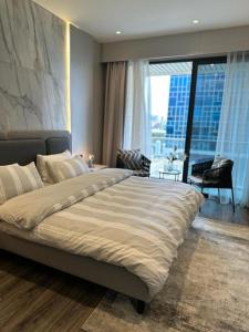 a large bed in a bedroom with a large window at Downtown pearl Amman in Amman +67 photos