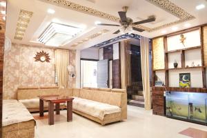 a living room with a couch and a ceiling fan at Nest & Fest in Indore