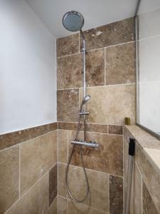 a shower with a shower head in a bathroom at Chambre avec salle d'eau privée in Les Arcs sur Argens +9 photos