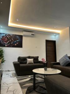 a living room with a couch and a table at The Apex Suites in Accra