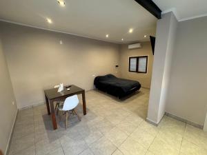 a bedroom with a bed and a table with a chair at Colon 533 Mono-Ambiente in Reconquista