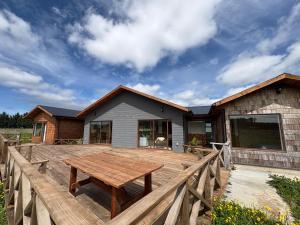 a wooden deck in front of a house at Casa Pradera in Frutillar