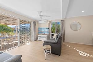 a living room with a couch and a table at Family-Friendly Flat with Balcony Views in Mooloolaba