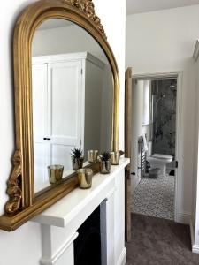 a mirror over a fireplace in a bathroom at Lavender Cottage, Welton in Welton +18 photos
