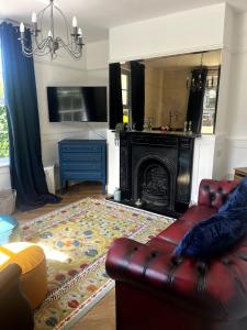 a living room with a couch and a fireplace at Lavender Cottage, Welton in Welton