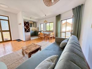 a living room with a blue couch and a table at Alba Abruzzo in Fossacesia
