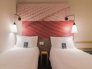 duas camas lado a lado em um quarto em ibis Erechim em Erechim mais 41 fotografias