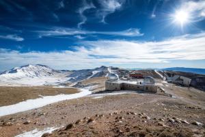 a building on top of a mountain with snow at Alba Abruzzo in Fossacesia