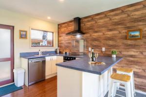 a kitchen with wooden walls and a counter top at Cozy, Functional,Private - HS65214 in Hanmer Springs