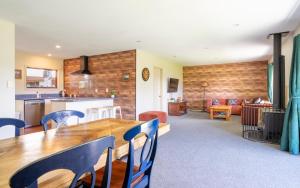 a kitchen and living room with a wooden table and chairs at Cozy, Functional,Private - HS65214 in Hanmer Springs