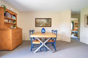 a dining room table with chairs and a vase on it at Cozy, Functional,Private - HS65214 in Hanmer Springs