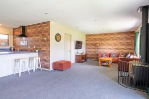 a living room with a kitchen and a couch at Cozy, Functional,Private - HS65214 in Hanmer Springs +10 photos