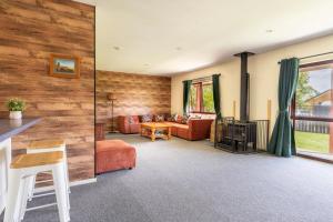 a living room filled with furniture and a fireplace at Cozy, Functional,Private - HS65214 in Hanmer Springs
