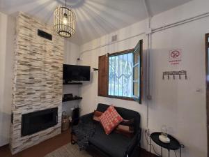 a living room with a couch and a fireplace at Antonia Rural House in Tacoronte
